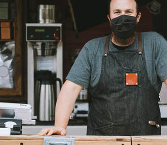 man behind counter wear cloth medical mask