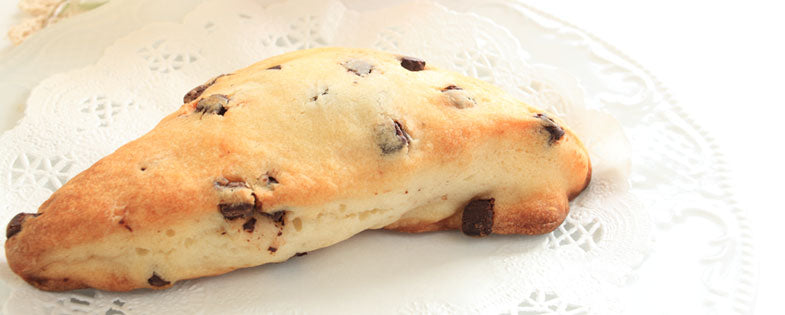 chocolate chip scone on a white doily