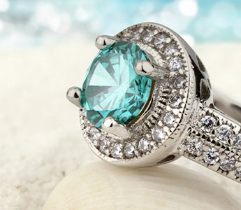 Aquamarine ring on seashell at the beach